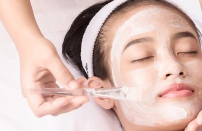 Young girl with facial mask at beauty salon